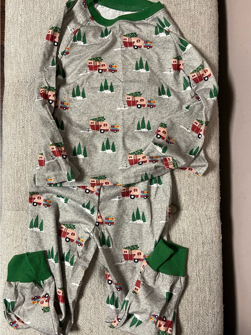 North Pile Trading Co. Kids Gray Holiday Truck Pajama Set with Green Trim.